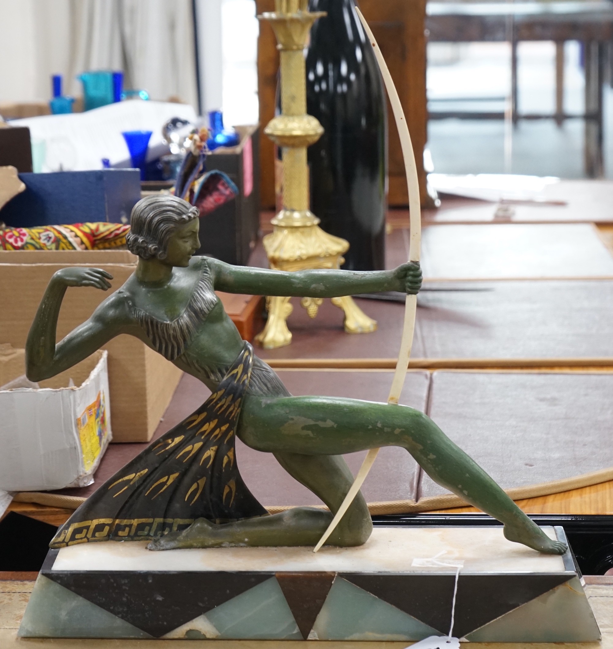 A French Art Deco spelter bronzed model of Diana The Huntress, with ornate marble base, after Uriano. 49cm wide